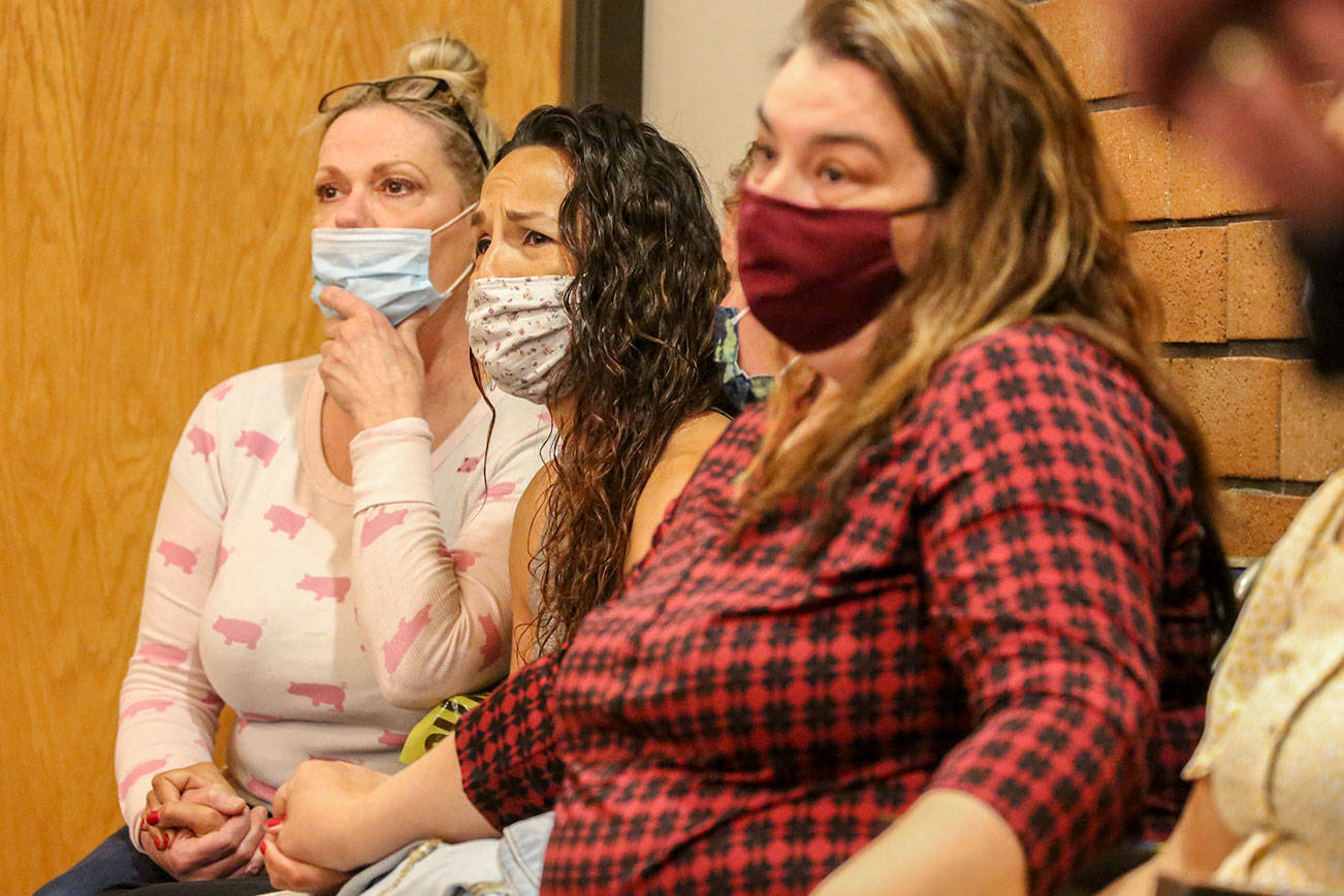 Allison Smith (left to right), Jamie Gonzales and Jodie Aney listen during the sentencing of Jeremy Pidgeon in Snohomish County District Court in Monroe on June 23, 2021.  (Kevin Clark / The Herald)