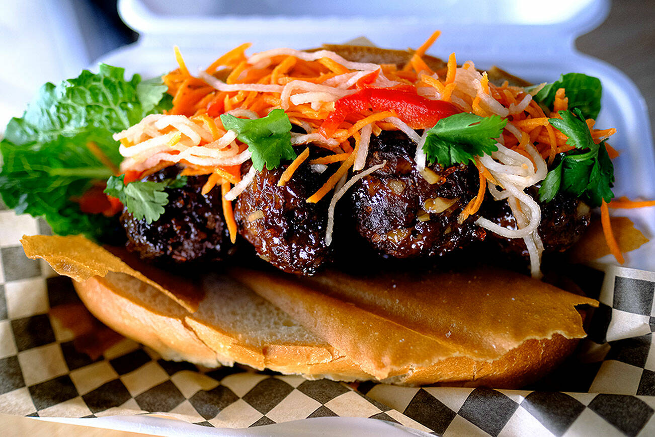 The lumpia sub at Lasa Sandwiches & Pearls is stuffed with hearty meatballs doused in sweet chili sauce, crunchy shards of egg roll wrappers, then topped with cilantro and pickled papaya, pepper and carrot. Wednesday, June 2, 2022. (Taylor Goebel / The Herald).