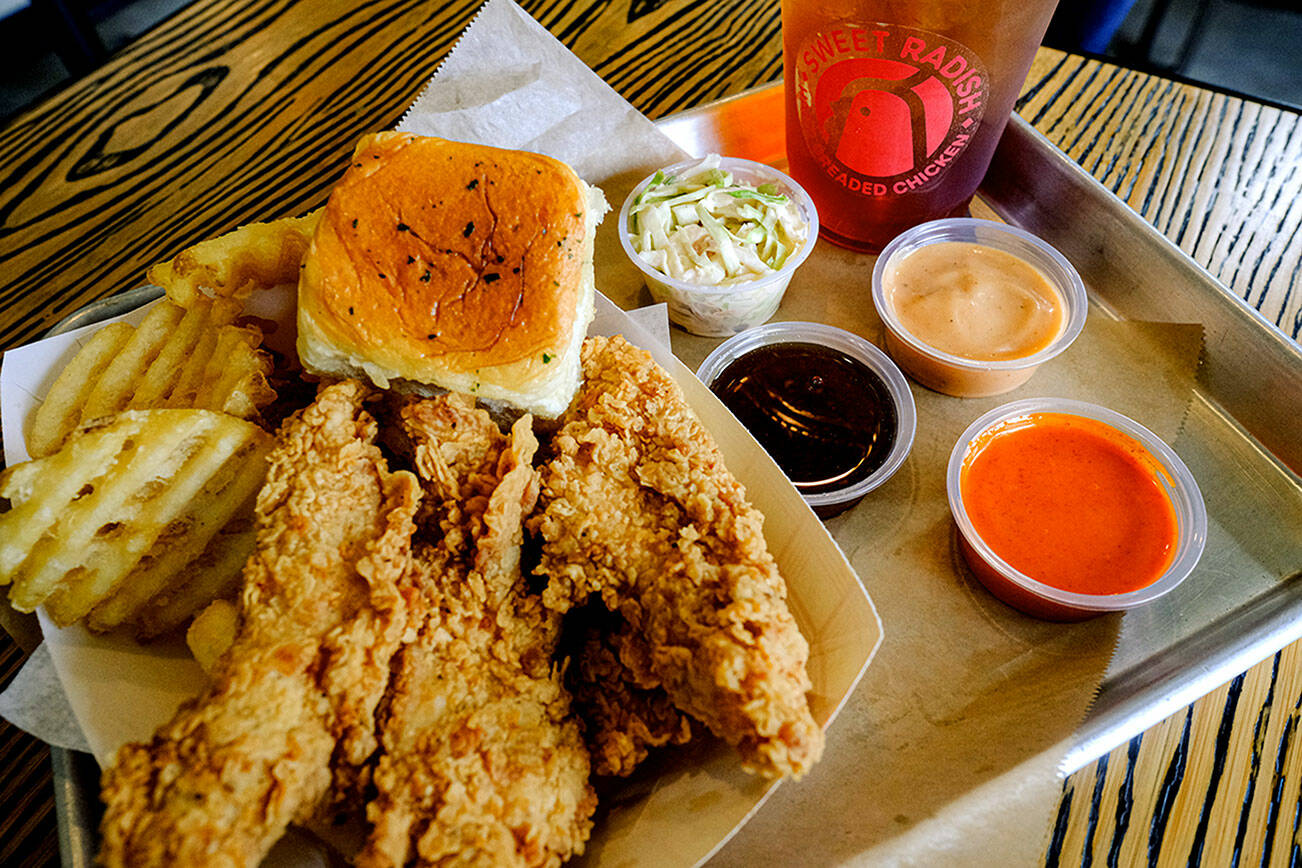 Sweet Radish's strip combo comes with hand-breaded chicken strips, crispy waffle fries, a buttery bun, their namesake sauce, coleslaw and an additional dipping sauce (or three). Friday, June 17, 2022. (Taylor Goebel / The Herald)