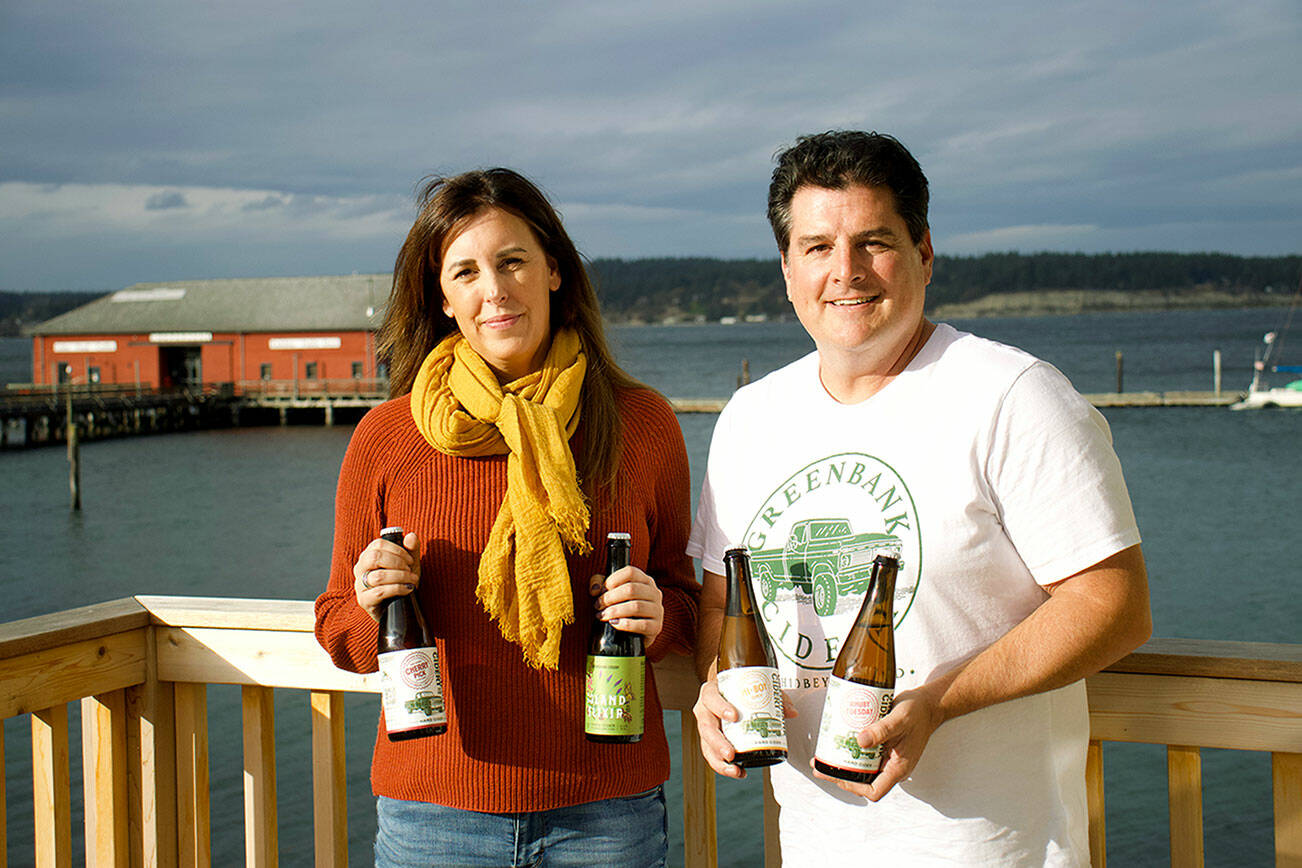 Kim Taylor, left, and Jeff Stoner co-own Greenbank Cidery, a newly opened taproom on Whidbey Island with eight varieties of cider on tap. (Rachel Rosen / Whidbey News-Times)