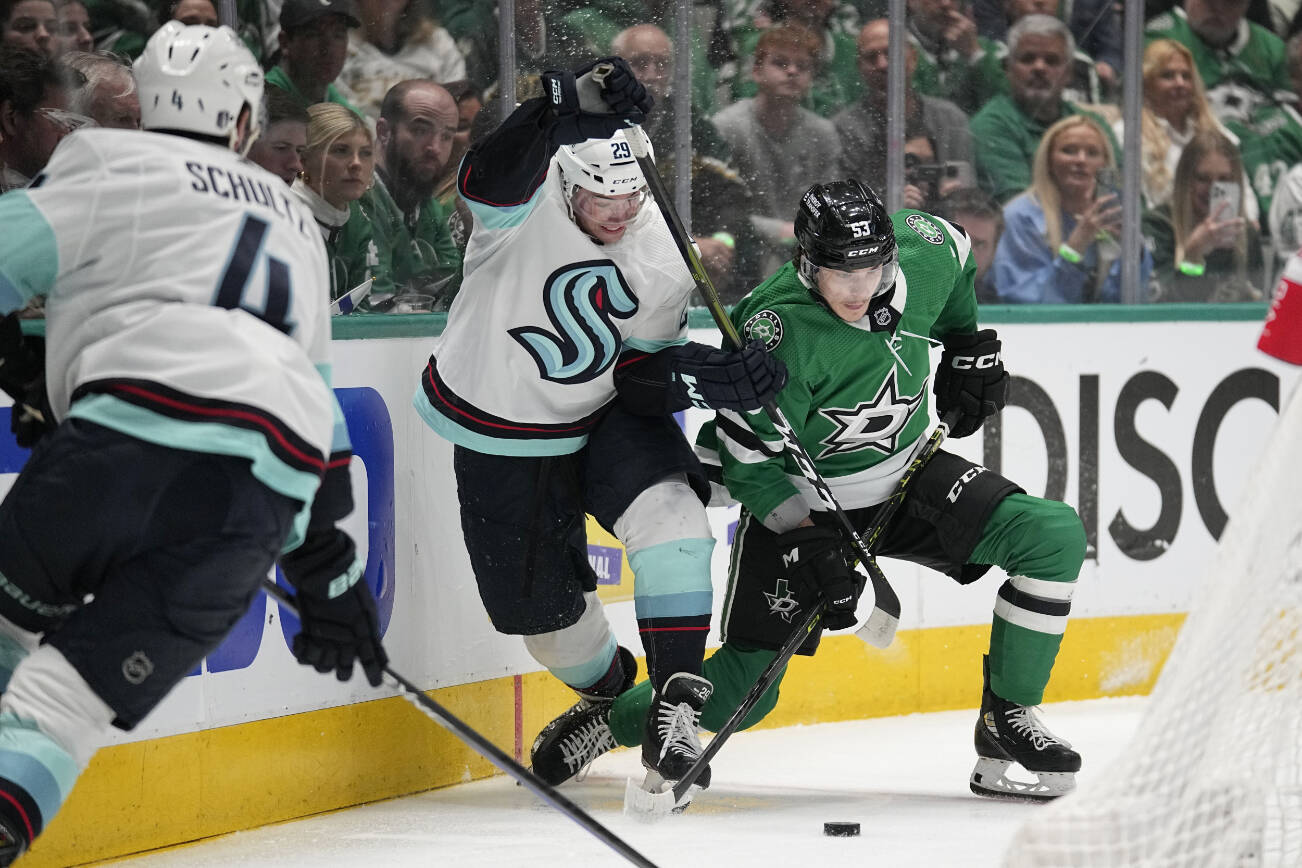 Seattle Kraken defenseman Vince Dunn (29) and Dallas Stars' Wyatt Johnston (53) compete for control of the puck in the first period of Game 2 of an NHL hockey Stanley Cup second-round playoff series, Thursday, May 4, 2023, in Dallas. (AP Photo/Tony Gutierrez)