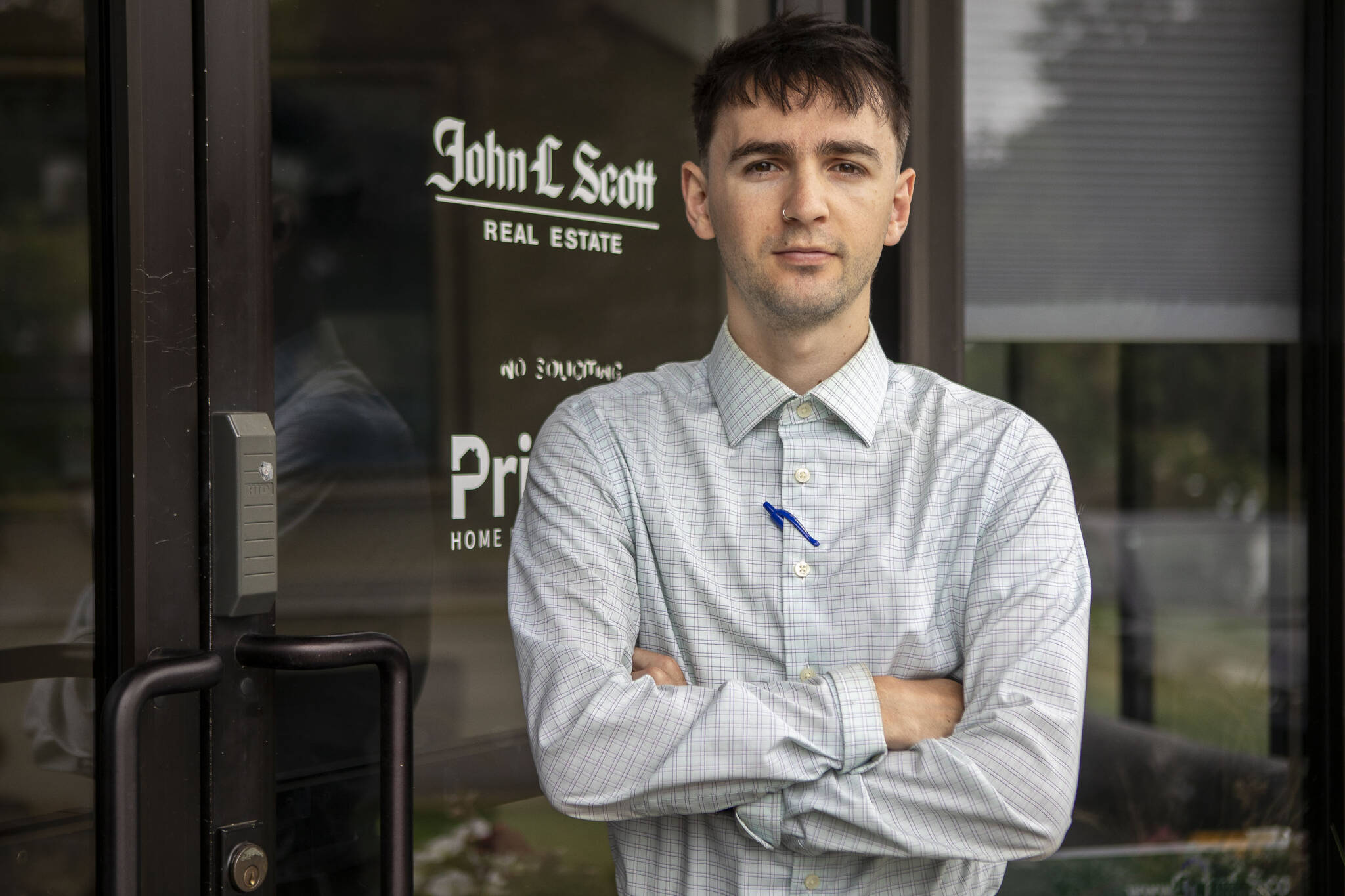 George Montemor poses for a photo in front of his office in Lynnwood on July 30. (Annie Barker / The Herald)