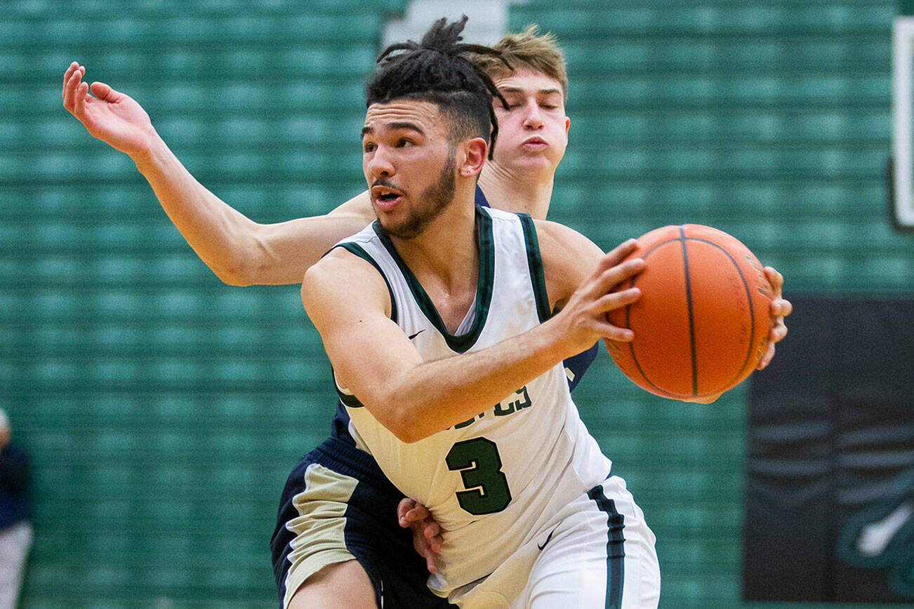 Jackson’s Trey Hawkins drives to the hoop during the game against Arlington on Tuesday, Nov. 28, 2023 in Everett, Washington. (Olivia Vanni / The Herald)