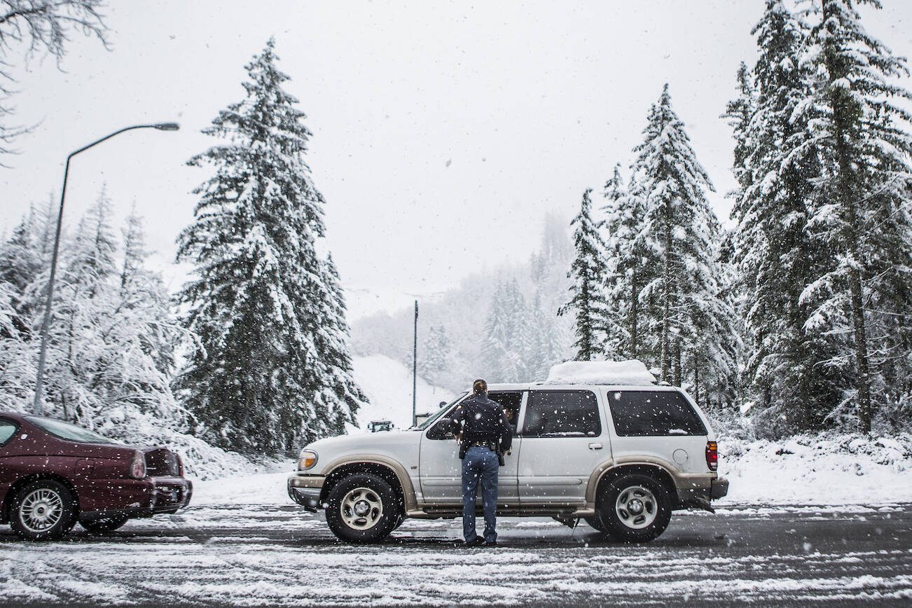 Trooper Heather Axtman talks to local residents hoping to get an escort into Index on Monday, Jan. 12, 2020 in Gold Bar, Wash. (Olivia Vanni / The Herald).