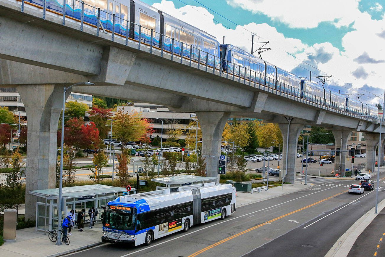 The 810 McCollum Park Community Transit bus at it's new stop in the shadow of the newly opened Northgate Light rail Station in Seattle. (Kevin Clark / The Herald)