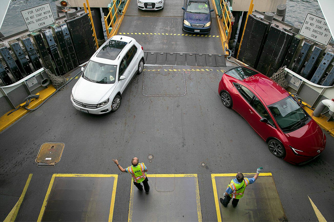 State Ferry workers direct drivers onto Washington Ferry MV Suquamish on Thursday, Sept. 7, 2023, at the terminal in Clinton, Washington. (Ryan Berry / The Herald)