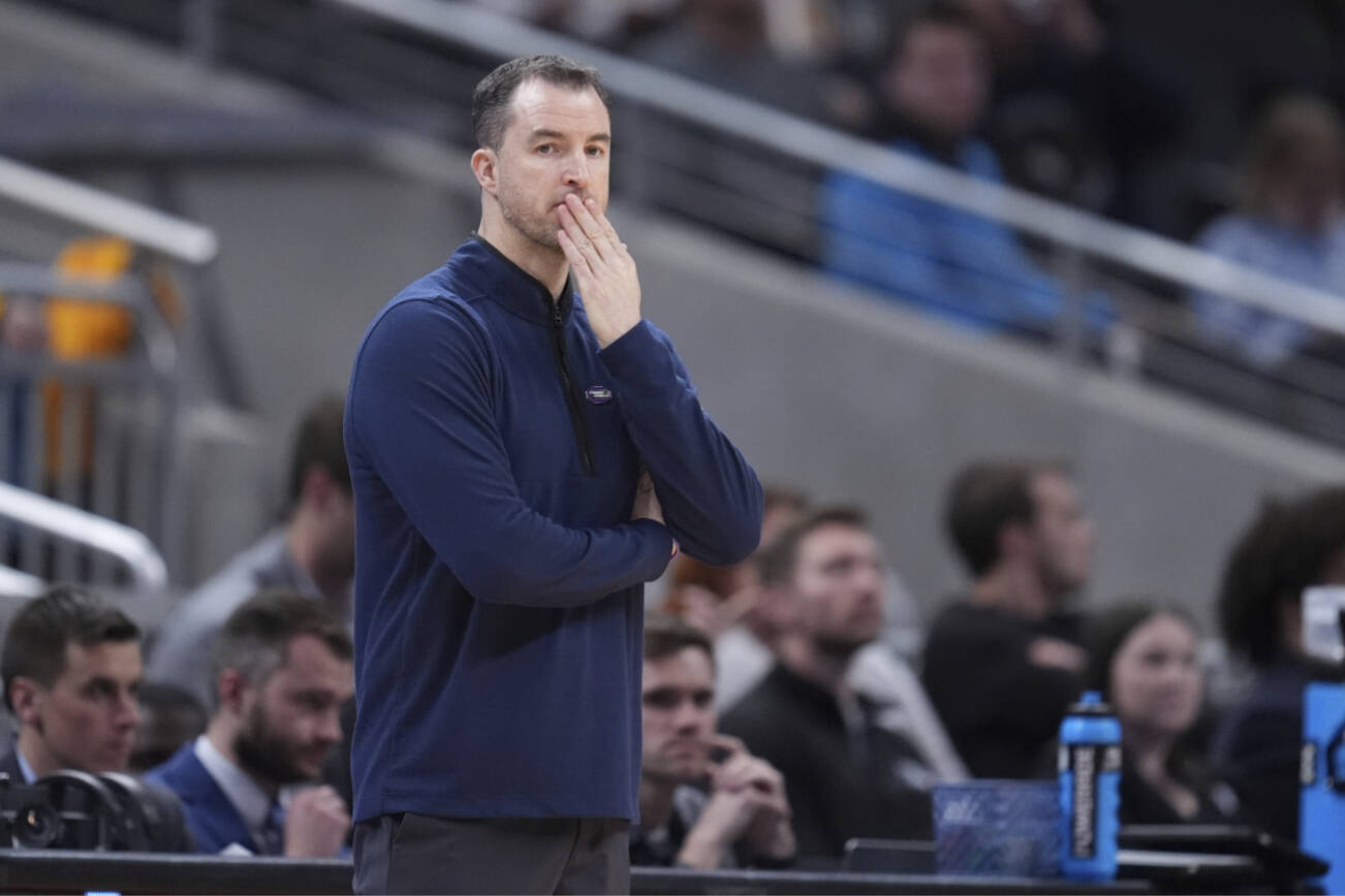 Utah State head coach Danny Sprinkle is seen on the sidelines during the first half of a second-round college basketball game against Purdue in the NCAA Tournament, Sunday, March 24, 2024 in Indianapolis. (AP Photo/Michael Conroy)