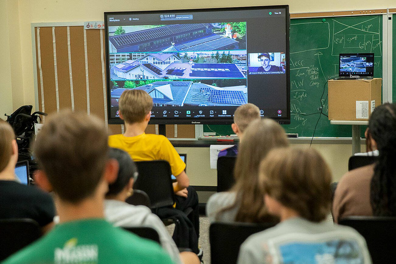 Maplewood Parent Cooperative School seventh and eighth grade students listen to Mason Rolph of Olympia Community Solar speak about different solar projects during a science class for the student's Sustainable Schools engineering units on Friday, June 7, 2024 in Edmonds, Washington. (Olivia Vanni / The Herald)