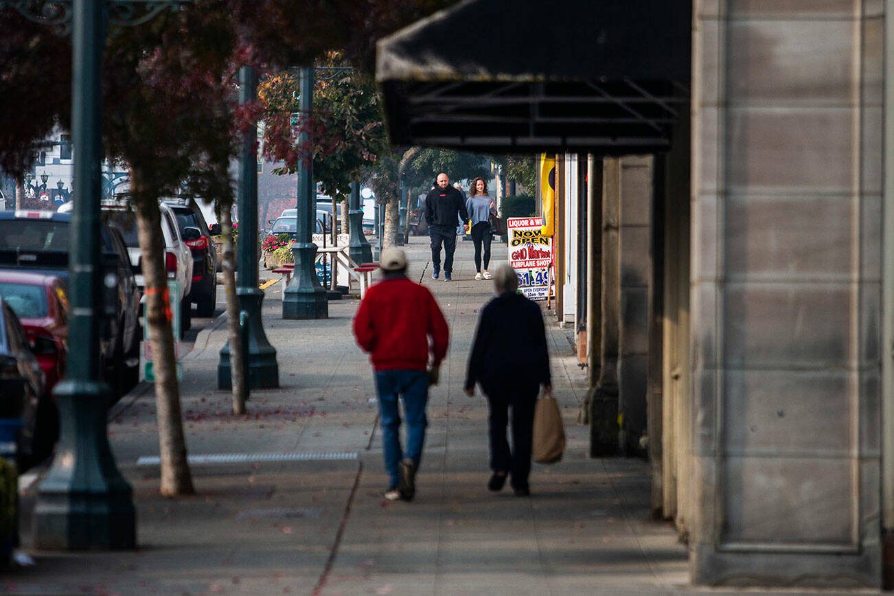 Two couples walk along Hewitt Avenue around lunchtime on Wednesday, Oct. 19, 2022 in Lynnwood, Washington. (Olivia Vanni / The Herald)