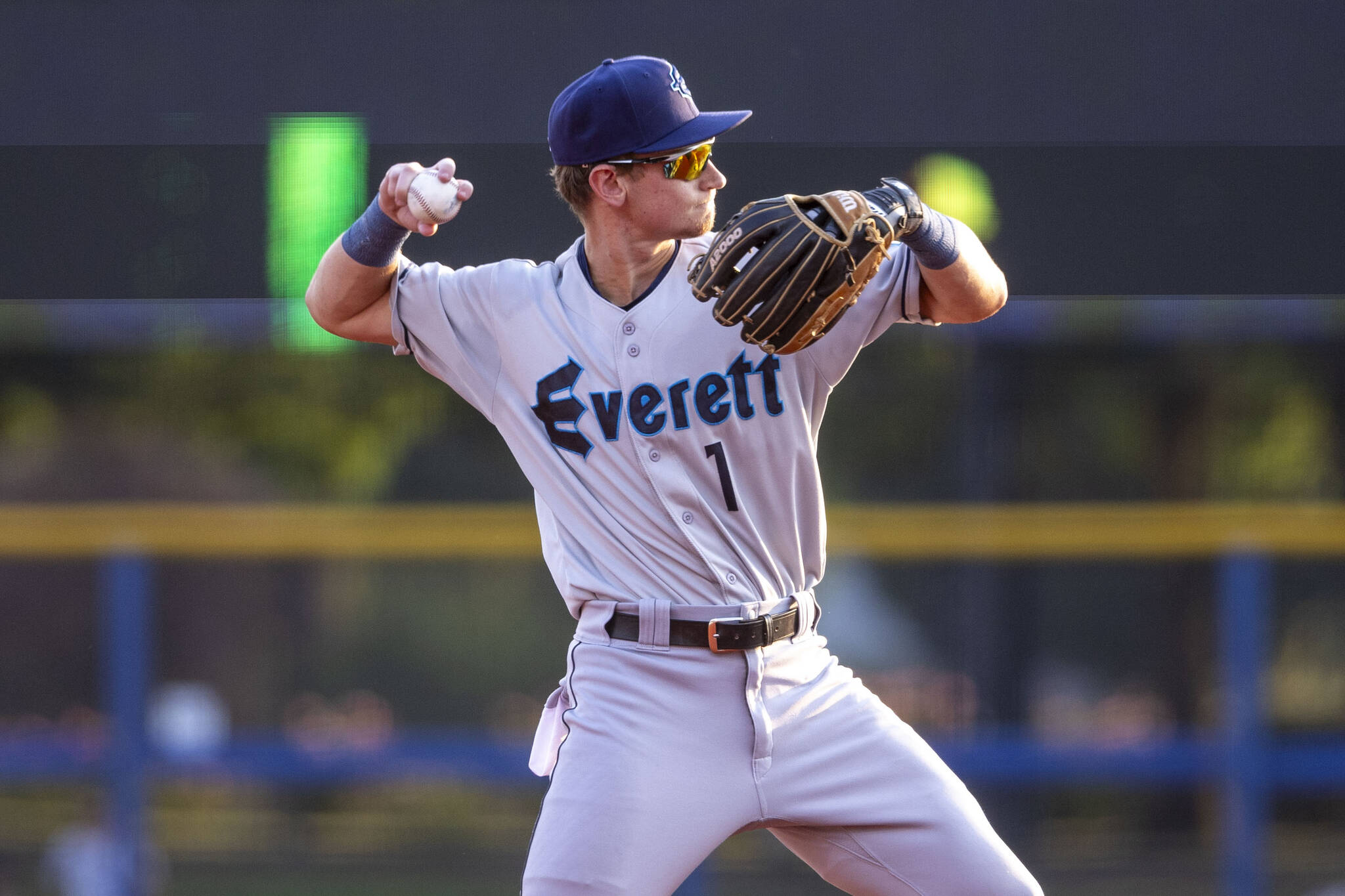 Everett AquaSox infielder Colt Emerson, the Seattle Mariners’ third-ranked prospect, throws a baseball to first base between innings during Everett’s game against the Hillsboro Hops on August 8, 2024, at Hillsboro Ballpark in Hillsboro, Oregon. Emerson will make his Funko Field debut this week. (Photo courtesy of Evan Morud / Everett AquaSox)