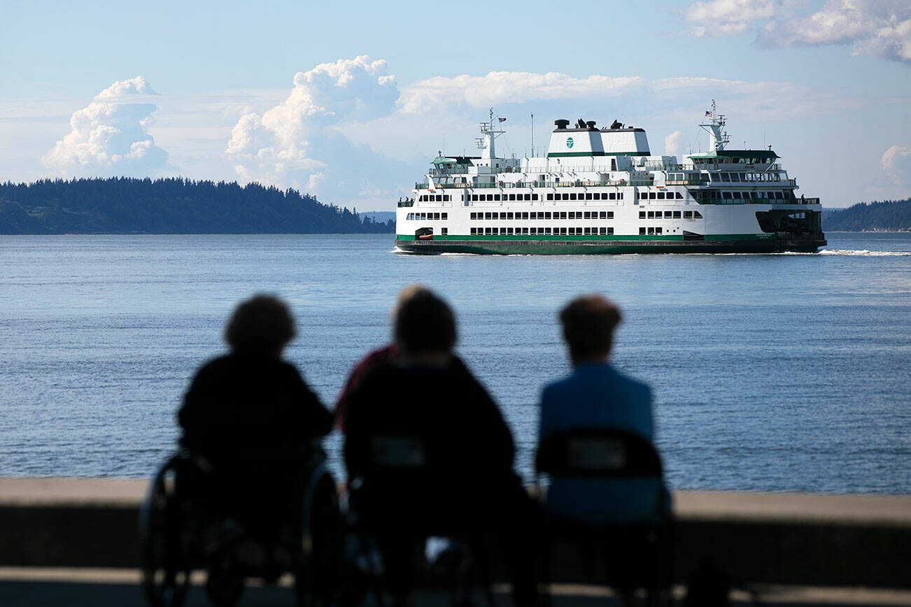 A ferry heads out from Mukilteo toward Clinton during the evening commute in 2022. (Ryan Berry / The Herald)