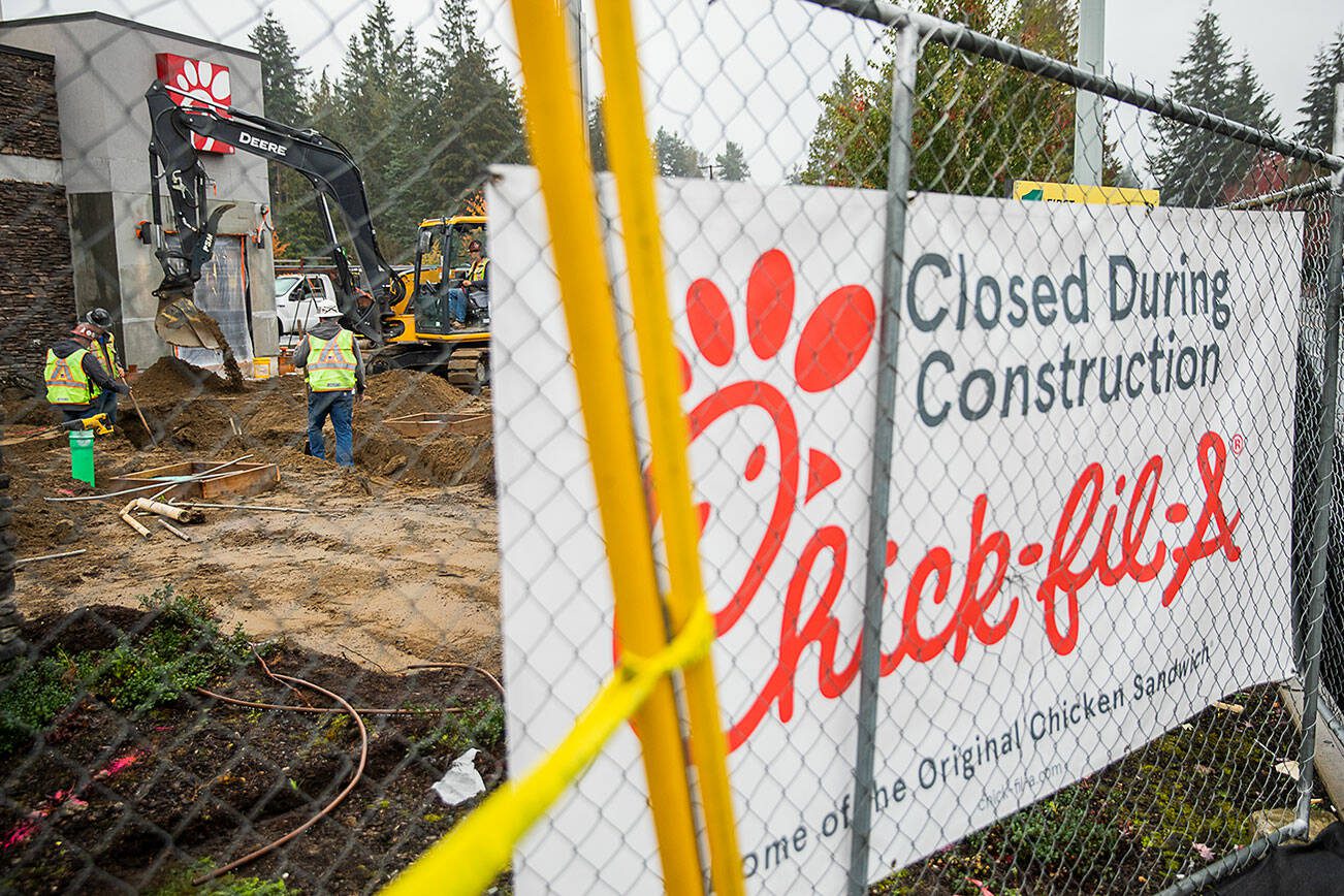 An excavator digs in front of Chick-fil-a along 88th Street on Tuesday, Oct. 8, 2024 in Marysville, Washington. (Olivia Vanni / The Herald)