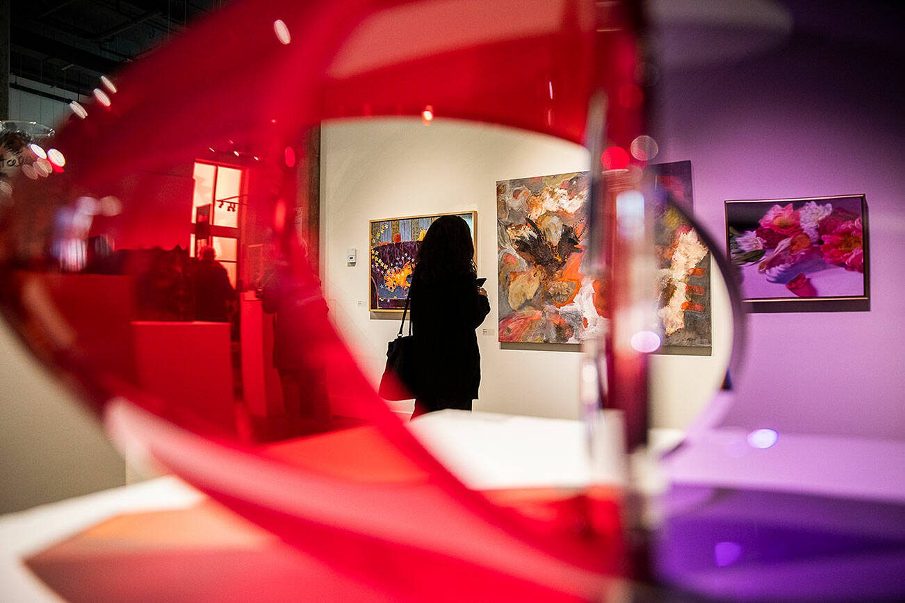 A person pauses to look at an art piece during the Schack Art Center’s 50th anniversary celebration on Thursday, Oct. 10, 2024 in Everett, Washington. (Olivia Vanni / The Herald)