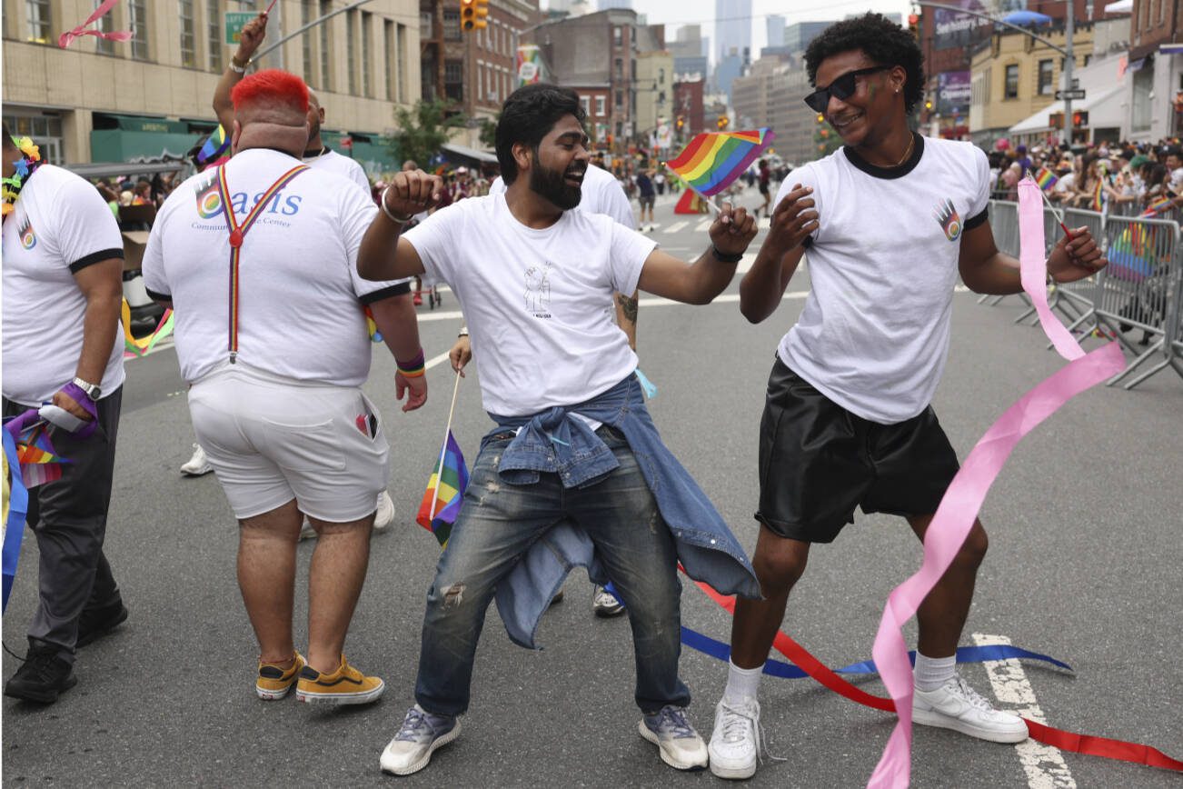 EDS.: RETRANSMISSION TO CORRECT BYLINE METADATA TO CAITLIN OCHS — People celebrate at the annual New York City Pride March in Manhattan on Sunday, June 30, 2024. The upcoming presidential election and laws threatening the rights of the LGBTQ community motivated many Pride attendees. (Caitlin Ochs/The New York Times)