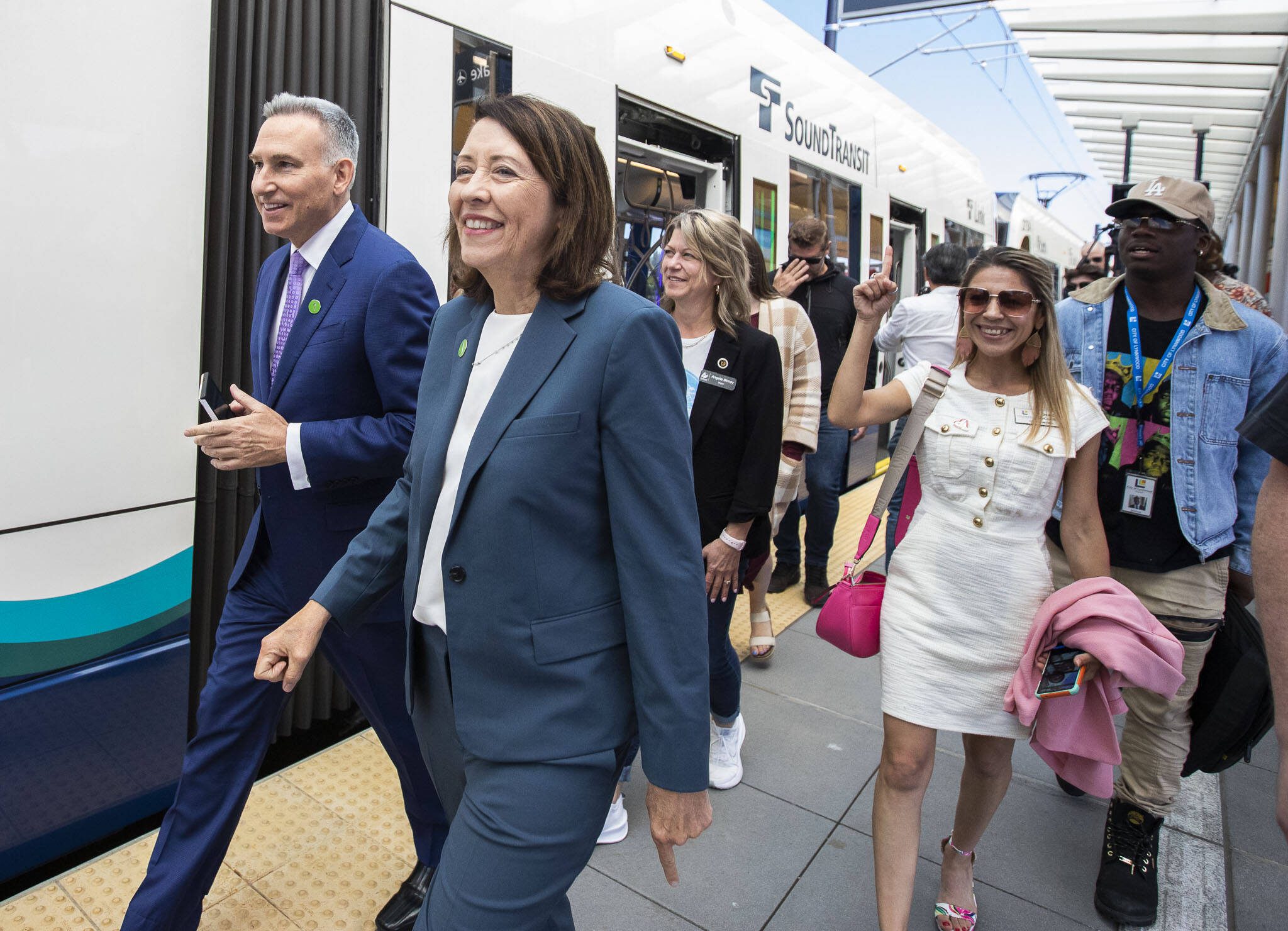 U.S. Sen. Maria Cantwell (center) walks through the Lynnwood Center Station to board the train during opening celebrations the Link light rail station’s opening on Aug. 30, in Lynnwood. (Olivia Vanni / The Herald file photo)