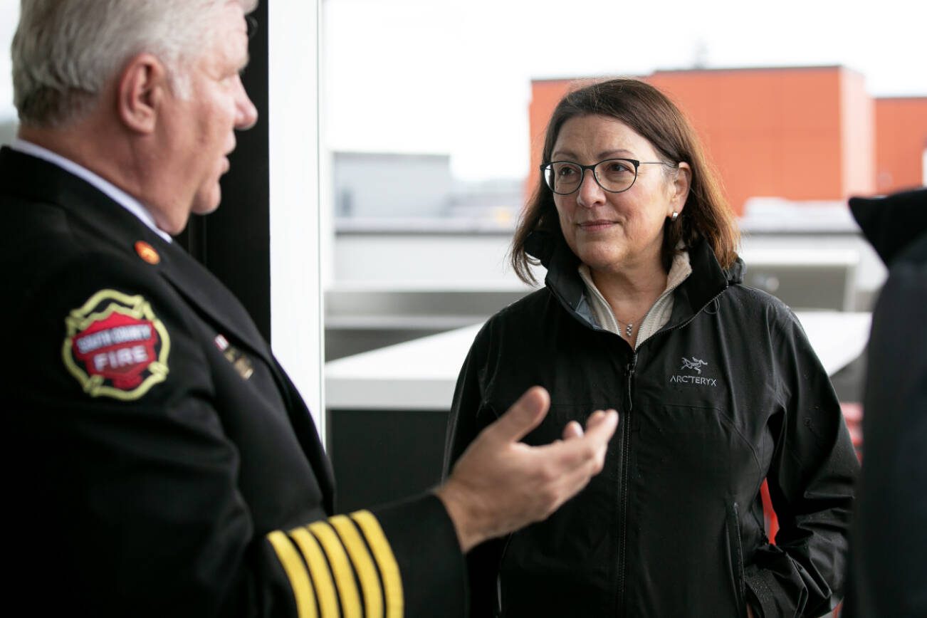 Rep. Suzanne DelBene and South County Fire Chief Bob Eastman chat during a tour and discussion with community leaders regarding the Mountlake Terrace Main Street Revitalization project on Tuesday, May 28, 2024, at the Traxx Apartments in Mountlake Terrace, Washington. (Ryan Berry / The Herald)