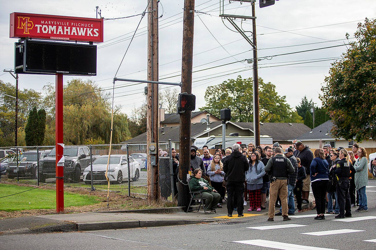 Parents of Marysville Pilchuck students, family, friends and community members gather outside of the high school to receive information from Marysville Police Commander Robb Lamoureux after the school was placed on locked down on Friday, Oct. 25, 2024 in Marysville, Washington. (Olivia Vanni / The Herald)