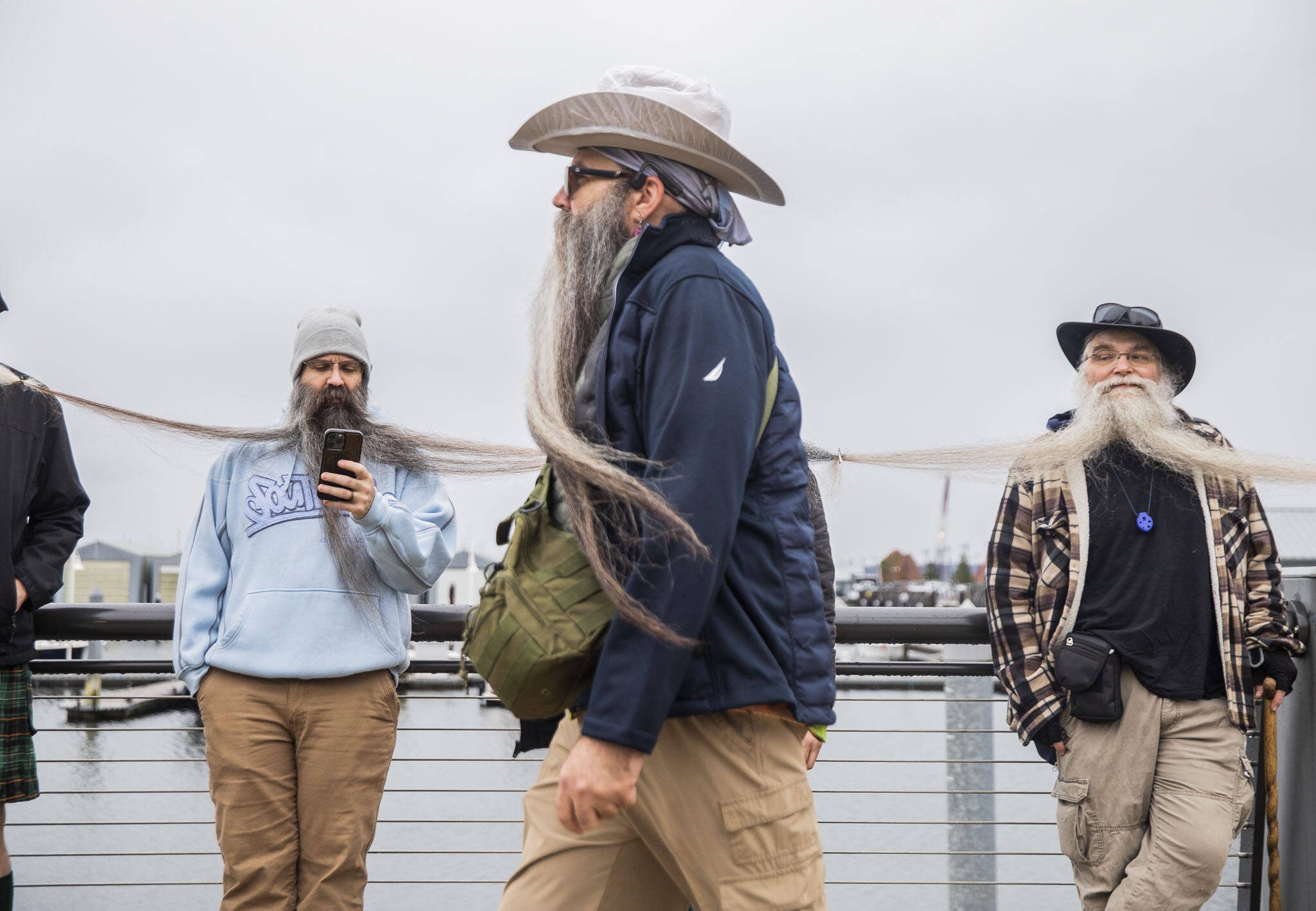 Participants in the Guinness World Record Beard Chain Attempt lineup to get their beards clipped together to be measured at Pacific Rim Plaza on Friday, Nov. 1, 2024 in Everett, Washington. (Olivia Vanni / The Herald)