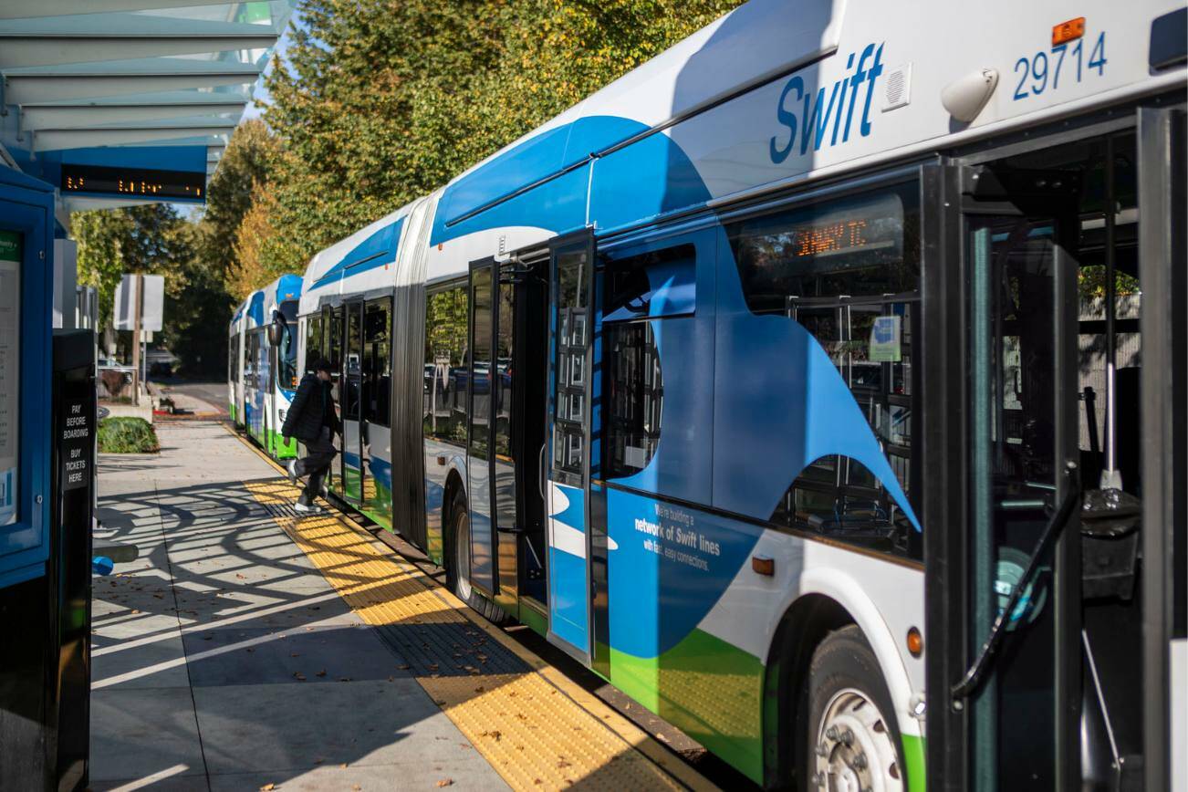 People board a bus at the Canyon Park Park & Ride Swift Green Line stop in Bothell, Washington on Wednesday, Oct. 18, 2023. (Annie Barker / The Herald)