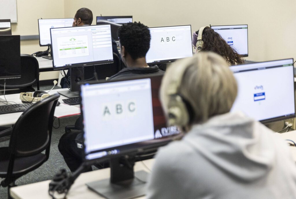 People works on the listening and reading portion of CASAS on computers at Refugee and Immigrant Services Northwest at Everett Community College on Friday, Nov. 15, 2024 in Everett, Washington. (Olivia Vanni / The Herald)
