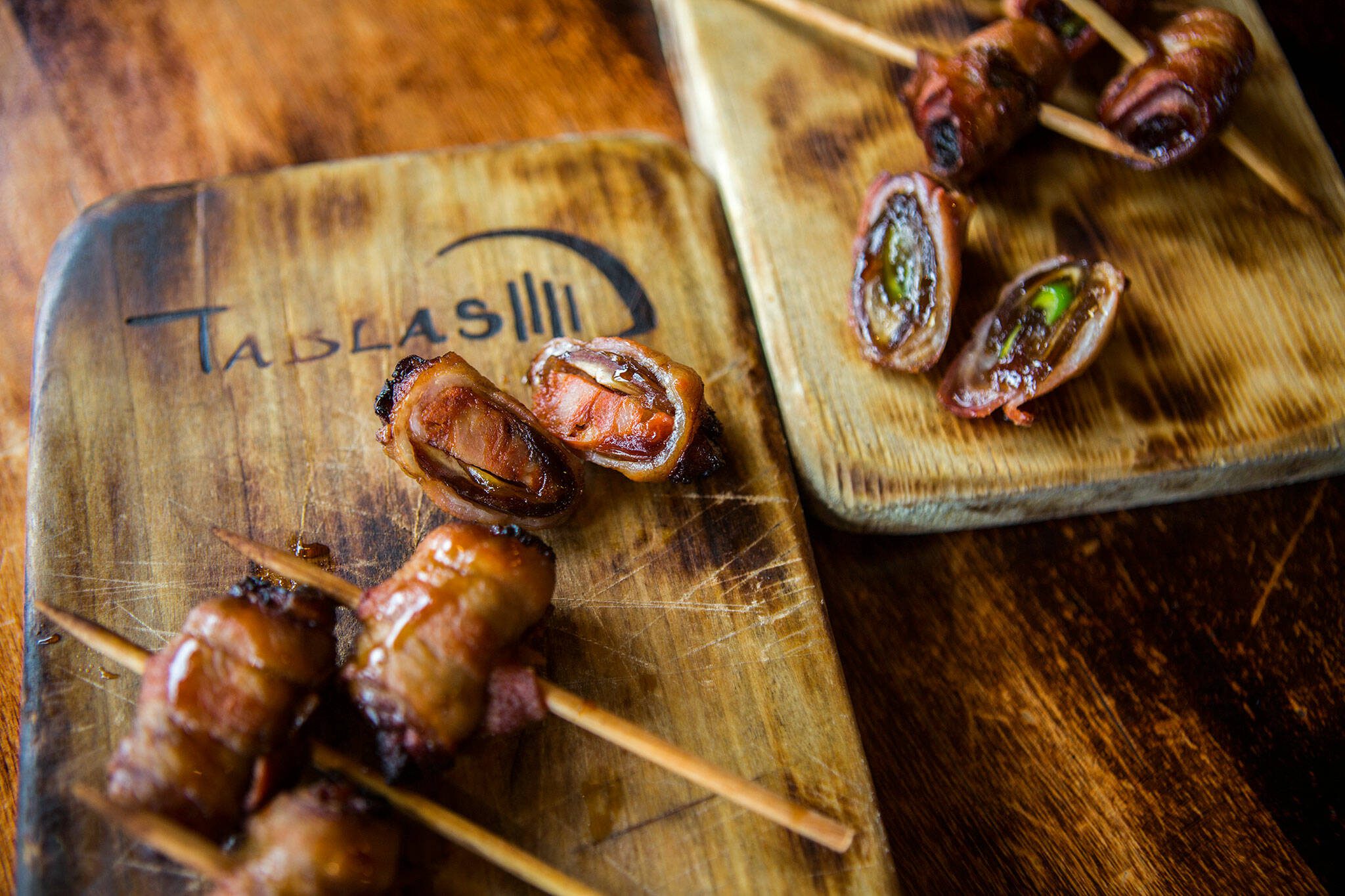 Bacon wrapped dates stuffed with poblano peppers and chorizo at Tablas Woodstone Taverna in 2019 in Mill Creek. (Olivia Vanni / Herald file)