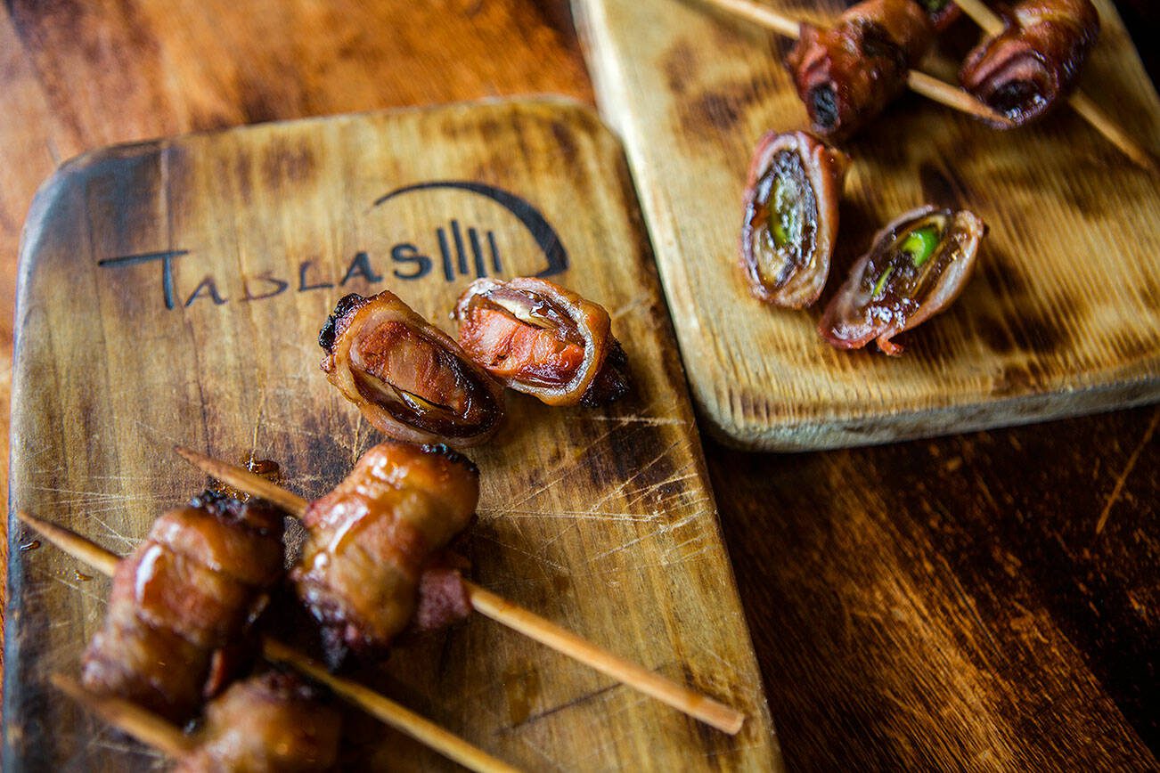 Bacon wrapped dates stuffed with poblano peppers and chorizo at Tablas Woodstone Taverna on Wednesday, July 17, 2019 in Mill Creek, Wash. (Olivia Vanni / The Herald)