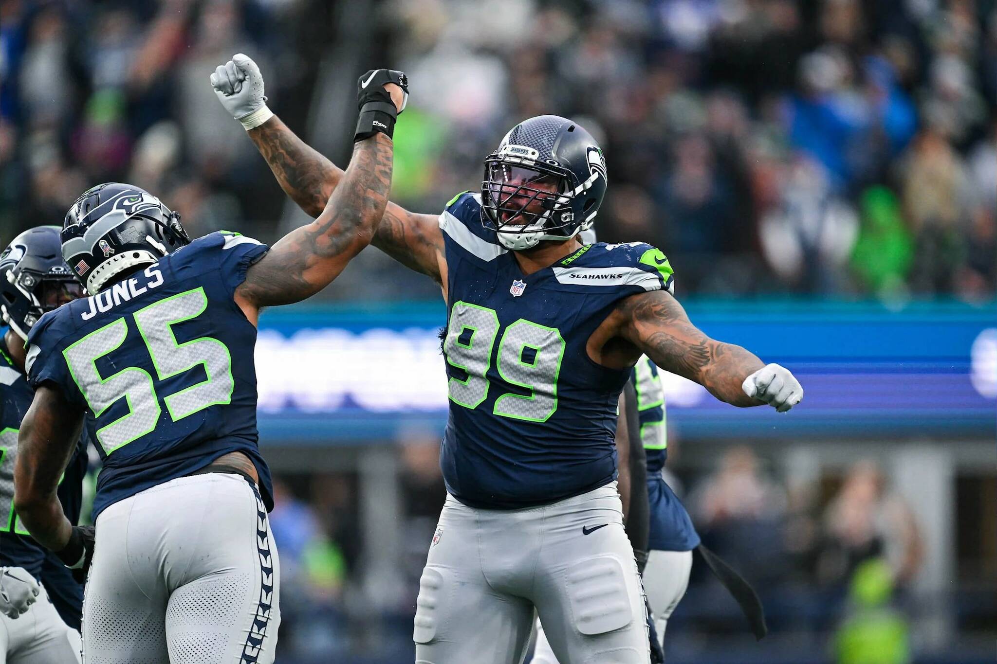 Seahawks linebacker Dre’Mont Jones (55) and Leonard Williams (99) celebrate after a play during Seattle’s 16-6 win over the Arizona Cardinals at Lumen Field on Nov. 24, 2024. (Photo courtesy of the Seattle Seahawks)