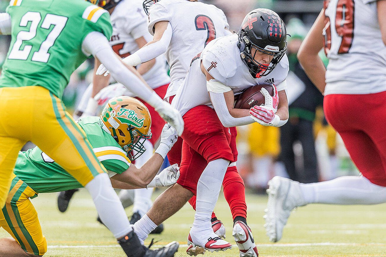 Archbishop Murphy’s Jevin Madison runs the ball while having his jersey pulled during the 2A semifinal game against Tumwater on Saturday, Nov. 30, 2024 in Tumwater, Washington.  (Olivia Vanni / The Herald)