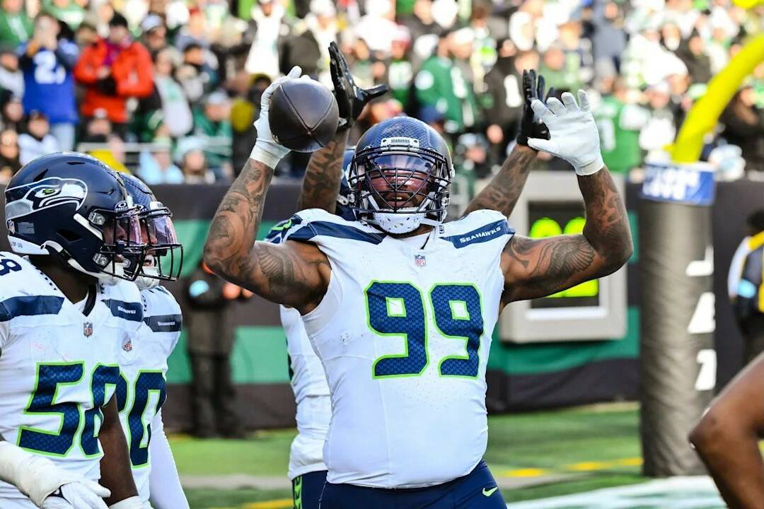 Seahawks defensive end Leonard Williams celebrates after his 92-yard pick-6 in Seattle’s 26-16 win over the New York Jets at MetLife Stadium on Dec. 1, 2024. (Photo courtesy of Edwin Hooper / Seattle Seahawks)