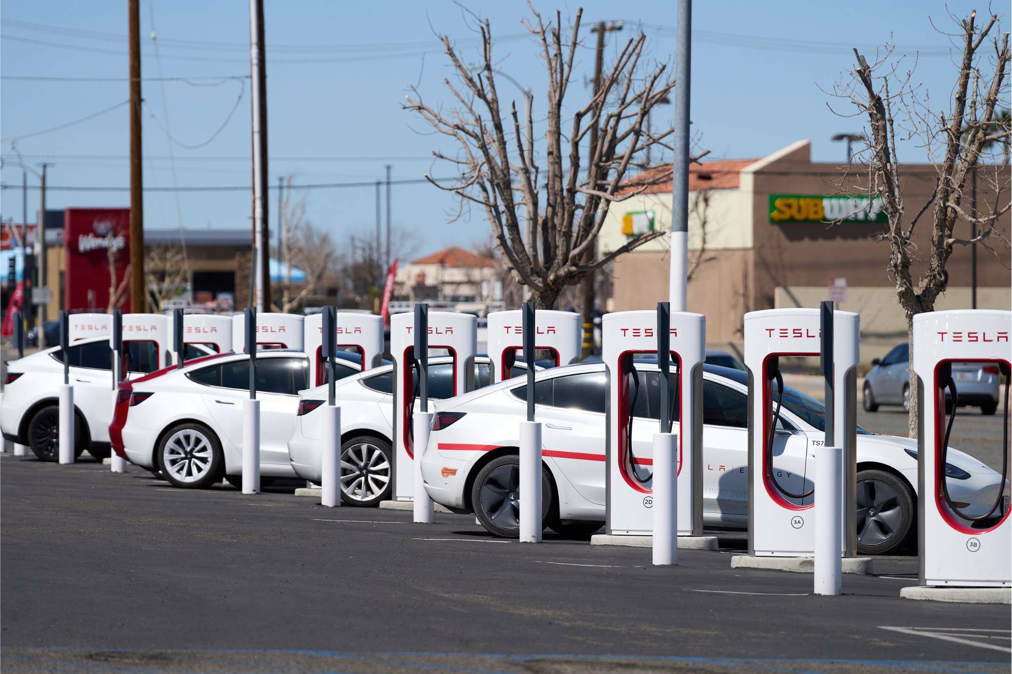 Teslas charging in Victorville, Calif., on March 11. Elon Musk, the chief executive of Tesla and one of President-elect Donald Trump’s biggest supporters, has said the government should eliminate all subsidies for electric vehicles. (Lauren Justice / The New York Times)