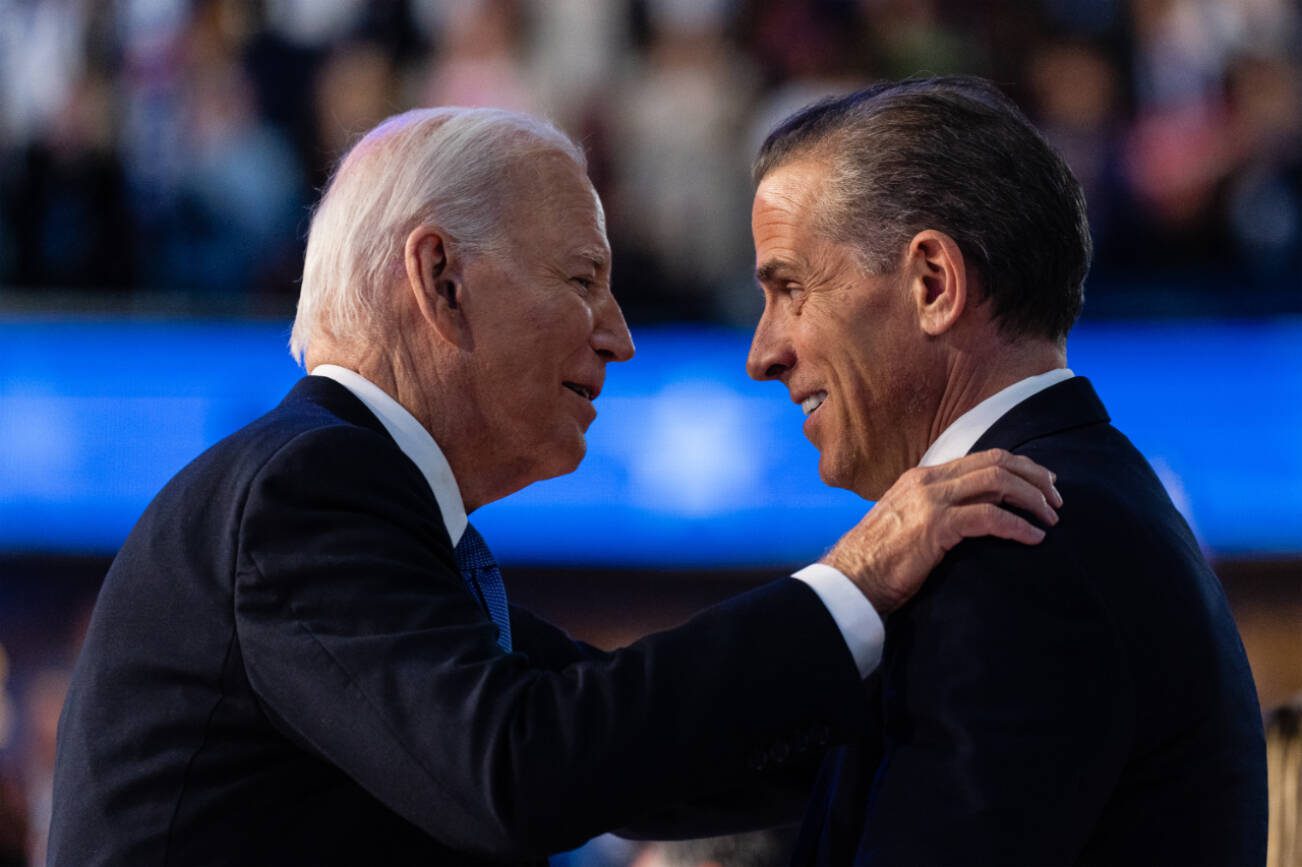 FILE — President Joe Biden embraces his son Hunter Biden after his speech on the first night of the Democratic National Convention in Chicago, Aug. 19, 2024. President Biden issued a full and unconditional pardon of his son Hunter on Sunday, Dec. 1, using the power of his office to wave aside years of legal troubles, including a federal conviction for illegally buying a gun. (Eric Lee/The New York Times)