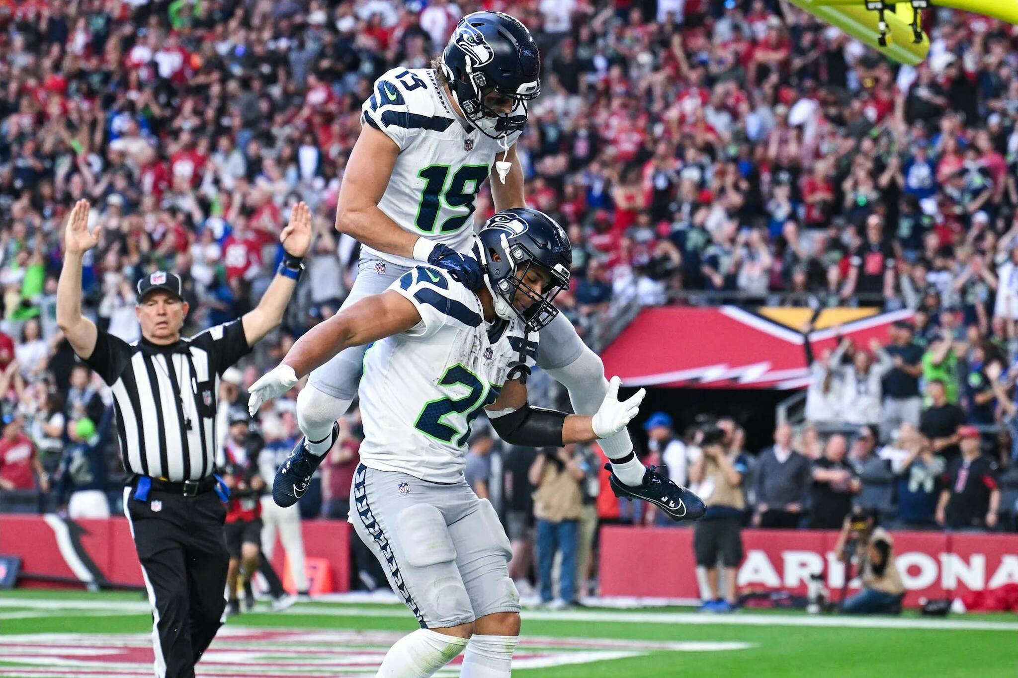 Seahawks receiver Jake Bobo (19) celebrates with running back Zach Charbonnet (26) after a touchdown during the Seahawks 30-18 victory at State Farm Stadium on Sunday, Dec. 8, 2024. (Photo courtesy of the Seattle Seahawks)