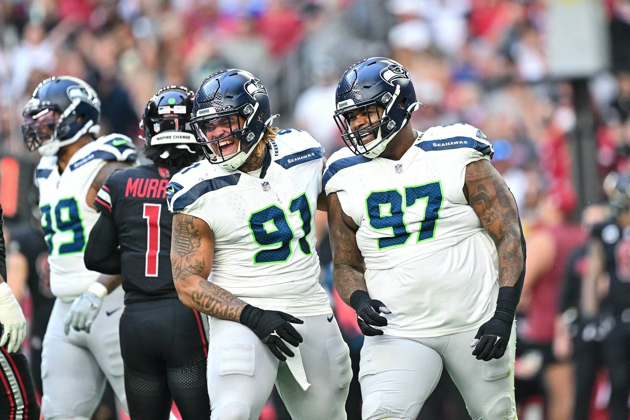 Seahawks defensive tackles Byron Murphy II (91) and Johnathan Hankins (97) celebrate after a defensive play against the Arizona Cardinals at State Farm Stadium on Sunday, Dec. 8, 2024. (Photo courtesy of the Seattle Seahawks)