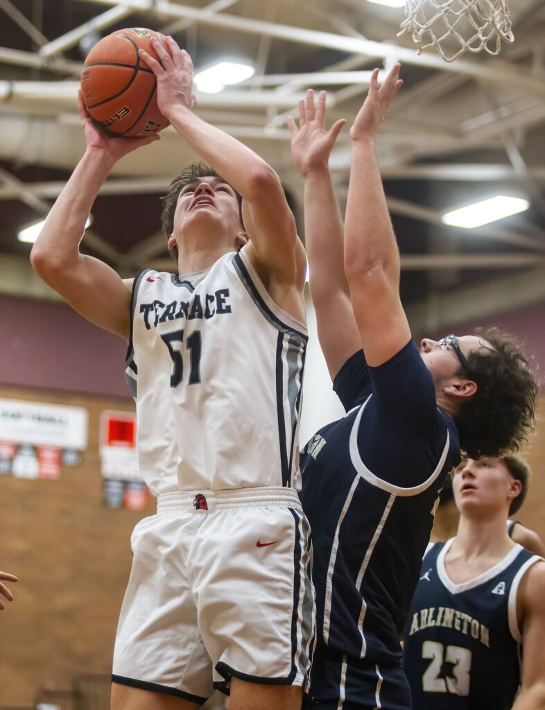 Mountlake Terrace’s Oliver Shaw-Jones tries to make a layup while being guarded during the game against Arlington on Tuesday, Dec. 10, 2024 in Mountlake Terrace, Washington. (Olivia Vanni / The Herald)
