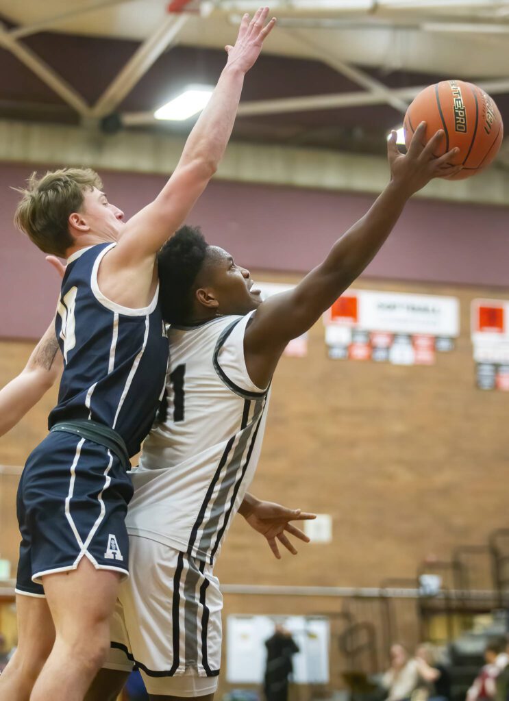 Mountlake Terrace’s Rayshaun Connor is fouled while making a layup during the game against Arlington on Tuesday, Dec. 10, 2024 in Mountlake Terrace, Washington. (Olivia Vanni / The Herald)
